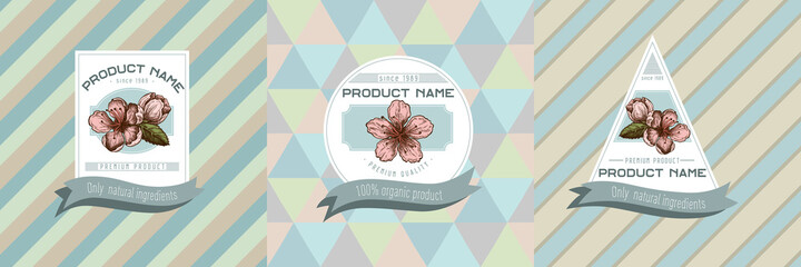 Three colored labels with illustration of peach flowers