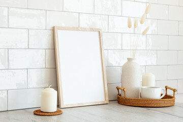 Wooden frame mockup and home decor on table in living room. Tiles bricks on background. Nordic,...