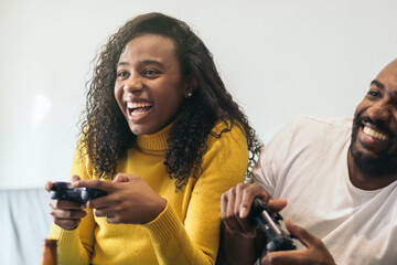 afro-american couple enjoying playing video game at home