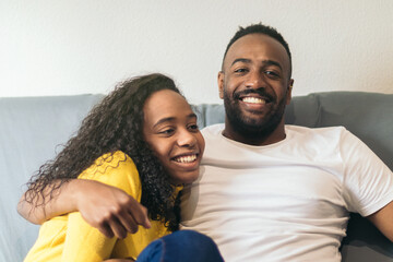 afro-american couple sitting on the sofa at home