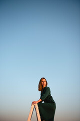 Woman standing on rooftop with blue sky on background