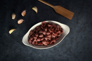 Dark Food Photography Pasta on white dish, dark background, text space.