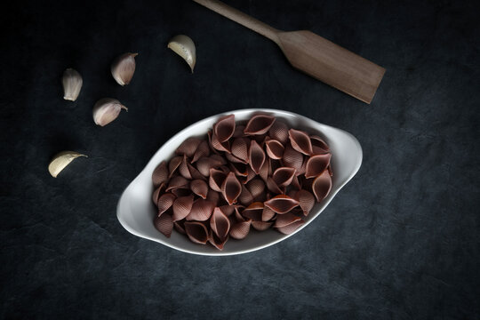 Dark Food Photography Pasta on white dish, dark background, text space.