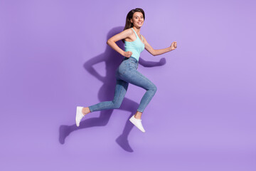 Fototapeta na wymiar Full size profile side photo of young happy dreamy young woman jump up run empty space isolated on violet color background