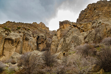 Low angle shot of huge yellow cliffs with dramatic dark clouds