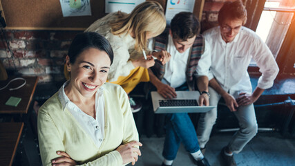 Portrait of handsome asian woman with team at office