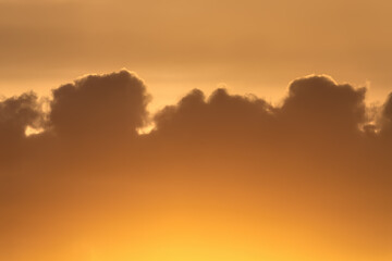 Beauty evening sky with warm cocoa color clouds, orange sunset. Natural abstract background.