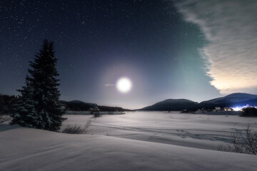 Nighttime winter landscape in the light of the full moon. Full moon in the polar region.