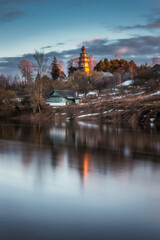 The Church of the Tikhvin Icon of the Mother of God in Torzhok at sunset in reflection of the Tver River