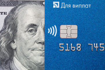 Debit card and US 100 dollar banknote