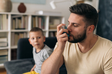 man using asthma pump at home