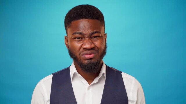 Young bearded african man expressing disgust and aversion