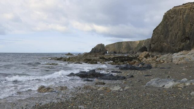 long rocky beach on cooper coast with cloudy landscape. Kilfarrasy Beach. Co.Waterford Coastline, Ireland