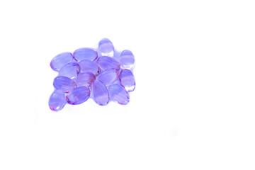 Shiny violet fish oil capsules isolated on a white background. Vitamin E. Copy space for your text