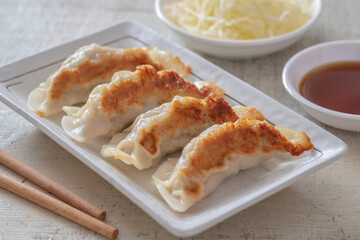 Fried dumplings Gyoza on plate and soy sauce