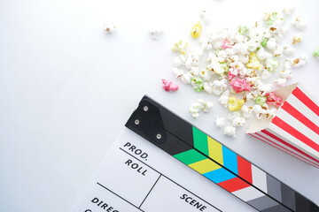 Movie clapper board and popcorn on white background 