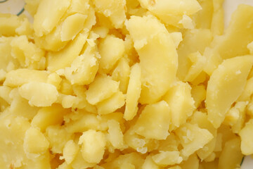 Close up of slice of raw potato in a bowl 