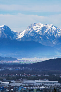 Snowy peaks of the Kamnik–Savinja Alps seen from Ljubljana (Golovec). Beautiful mountains with urban landscape in foreground.