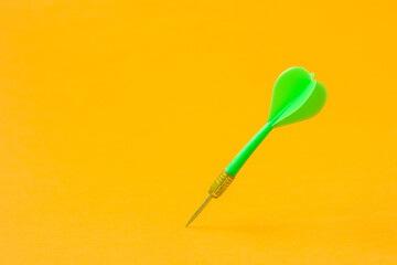 Green dart arrow on the yellow background