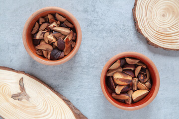 Chopped cut avocado seeds in clay bowls top view. Drying hass avocado seeds. Zero waste concept.