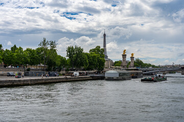 Fototapeta na wymiar The Seine river and Eiffel Tower under summer blue sky