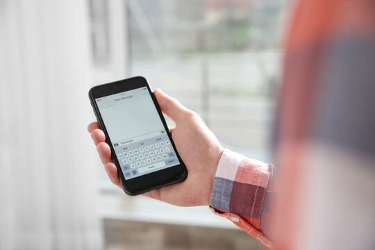 Man Sending Message With Text I Love You Indoors, Closeup