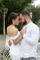 Fototapeta premium Stylish couple gently hugging. Happy sensual wedding couple embracing. Romantic moments of newlyweds.