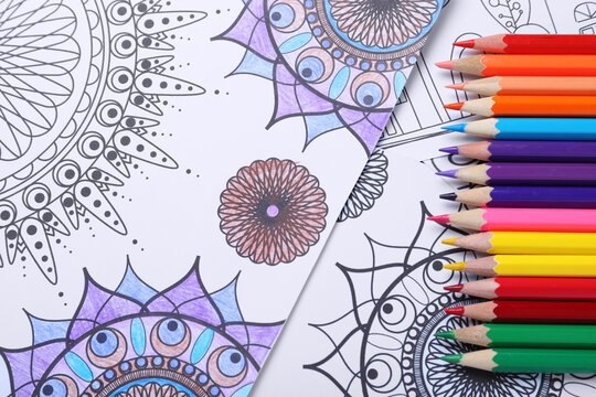 Pencils on antistress coloring pages, top view