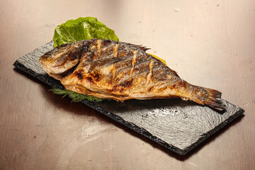 Grilled dorada servel lemon slice