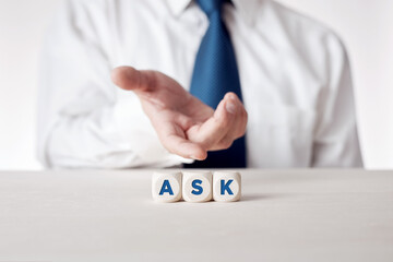 Businessman presenting the wooden cubes with the word ask.