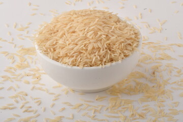 uncooked long brown rice isolated on white