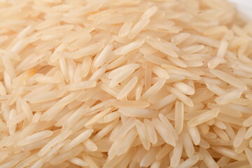 uncooked long brown rice isolated on white