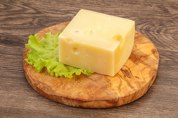 Emmental cheese over wooden board