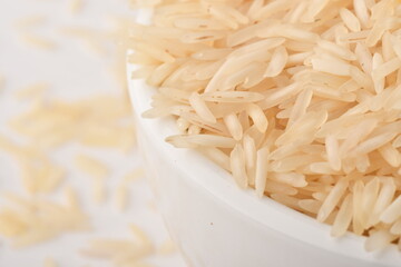 uncooked long brown rice isolated on white