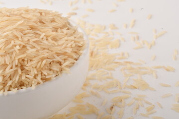 uncooked long brown rice isolated on white