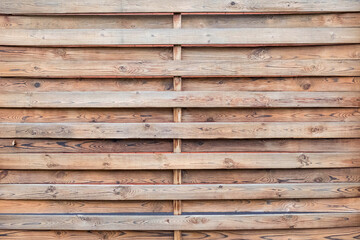 Wooden fence made of brown boards. No one