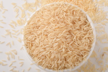 uncooked long brown rice isolated on white