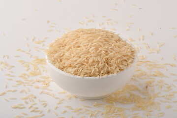 uncooked long brown rice isolated on white