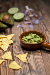 avocado dip flavored with garlic, chili, pepper, and lime juice with corn nachos