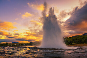 Eruption of Strokkur geyser in Iceland at sunset - obrazy, fototapety, plakaty