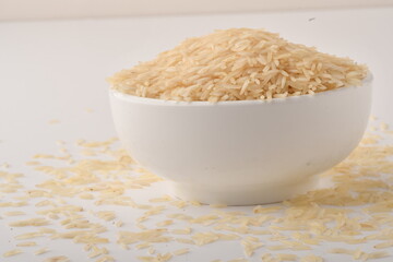 uncooked long brown rice isolated on white