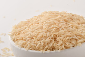 uncooked long brown rice isolated on white