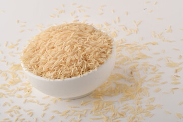 uncooked long brown rice isolated on white