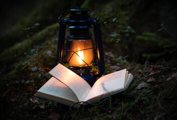 Fototapeta na wymiar A magic kerosene lamp and the book in the dark forest