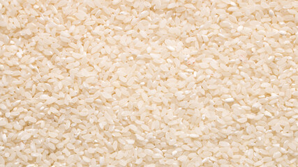 Raw white rice grain food background. Healthy eating. Top view.