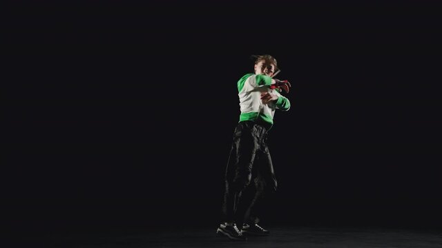B-Girl dancing upper break dance on a black background 