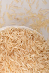 uncooked long brown rice isolated on white