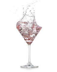 pink gin tonic splashing out of a martini cup isolated on white background