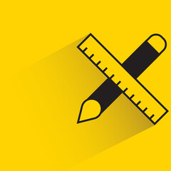 brush and ruler with shadow on yellow background