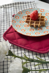 Healthy whole grain Checkered pattern shape of homemade waffle with fresh strawberry.